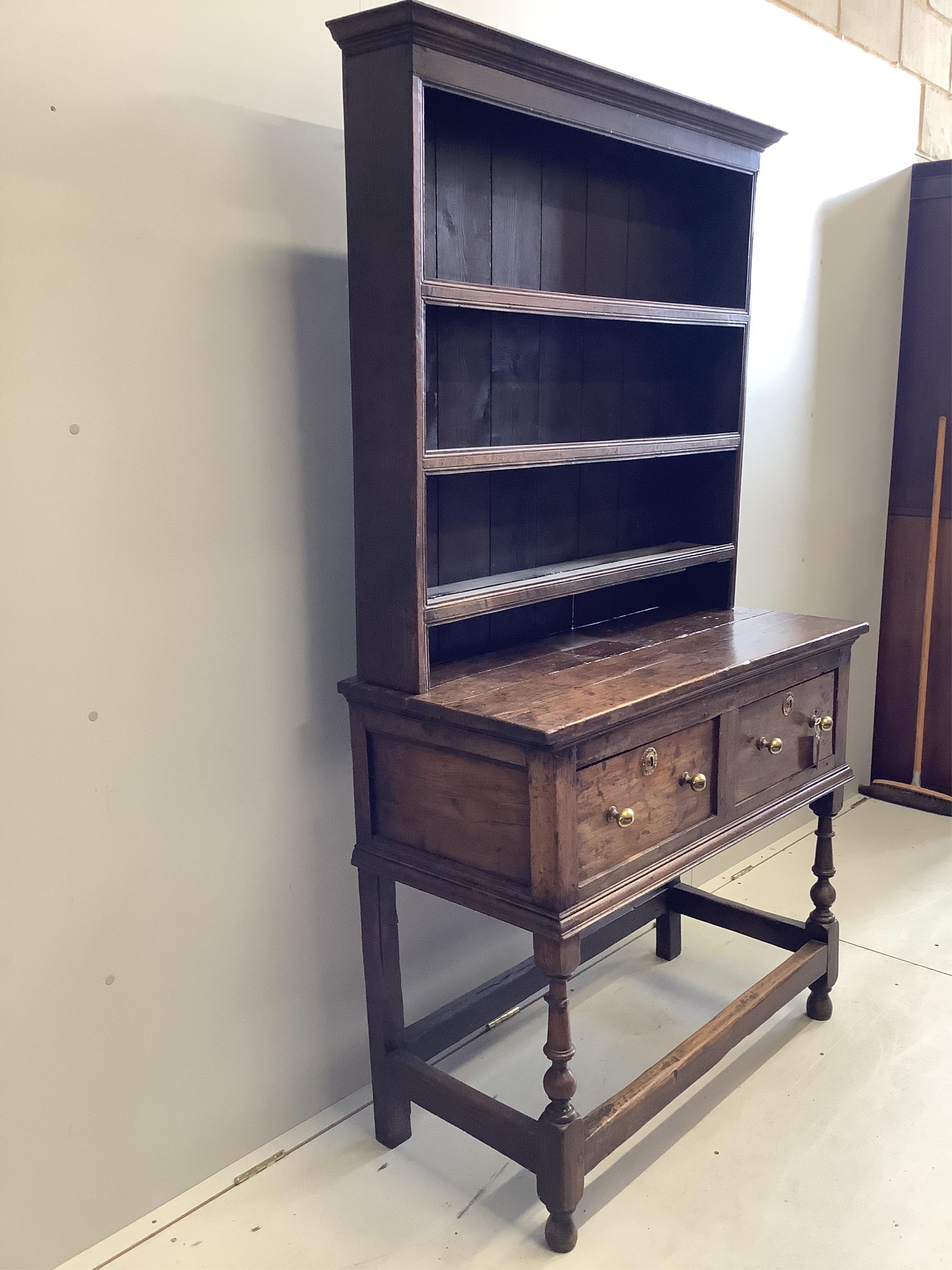 A small mid 18th century oak dresser, width 109cm, depth 49cm, height 191cm. Condition - poor to fair